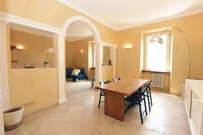 a dining room with a wooden table and chairs at Cattaneo Flat in Rome