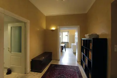 a hallway with a room with a door and a table at Cattaneo Flat in Rome