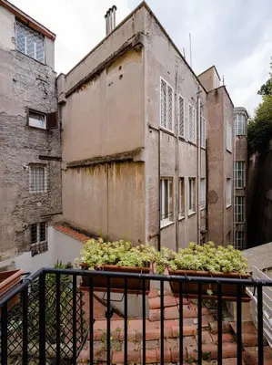a balcony with potted plants on top of a building at Via Francesco Crispi Private Apartment in Rome