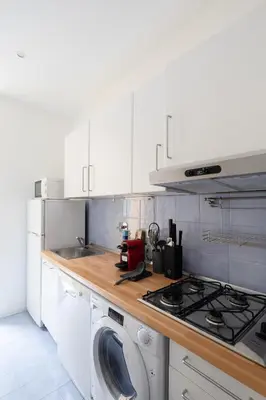 a kitchen with a stove and a washing machine at Via Francesco Crispi Private Apartment in Rome