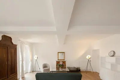 a living room with a green couch and a table at Via Francesco Crispi Private Apartment in Rome