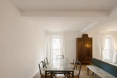 a dining room with a glass table and a couch at Via Francesco Crispi Private Apartment in Rome