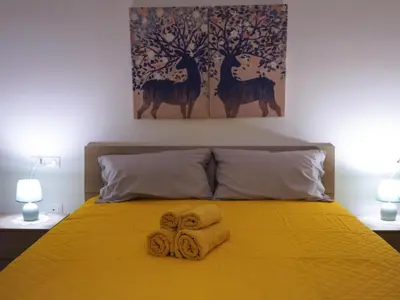a bedroom with a bed with two towels on it at Pandora apartments in Rome