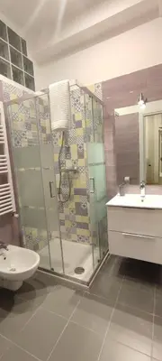 a bathroom with a shower and a toilet and a sink at Portonaccio suite - Stazione Tiburtina - Università - Metro B in Rome