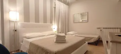 a white room with two beds and a sink at Portonaccio suite - Stazione Tiburtina - Università - Metro B in Rome