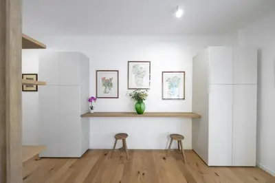 a room with two stools and a shelf on the wall at Vatican Steps, Suite Mary, Strollingrome in Rome