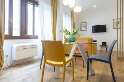 a living room with a dining room table and chairs at Vatican Steps, Suite Mary, Strollingrome in Rome