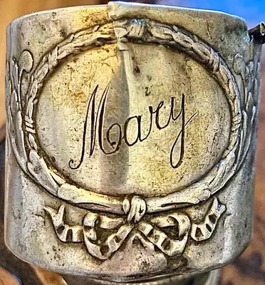 a metal bracelet with the word money written on it at Vatican Steps, Suite Mary, Strollingrome in Rome