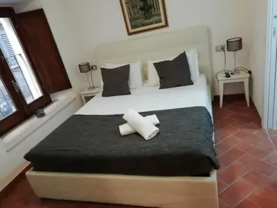 a bedroom with a large white bed with two pillows at Relais Arco Della Pace in Rome