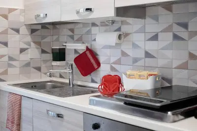 a kitchen with a sink and a red bag on the counter at Easy Apartment in Rome