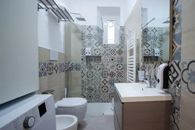a bathroom with a toilet and a sink at Easy Apartment in Rome