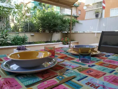 a table with plates and bowls on a colorful table cloth at Casa con Giardino - Metro A Cornelia Vaticano a sole 4 fermate in Rome