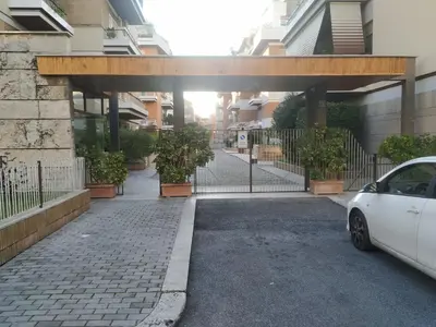 a car parked in front of a gate with plants at Casa con Giardino - Metro A Cornelia Vaticano a sole 4 fermate in Rome