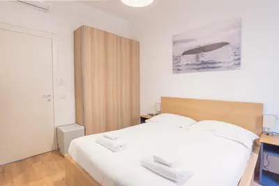 a bedroom with a white bed with two white towels at Residence San Paolo in Rome