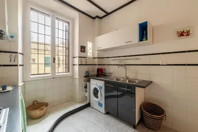 a bathroom with a sink and a washing machine at GuestHost - Trastevere Delightful Apartment in Rome