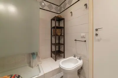 a small bathroom with a toilet and a shower at GuestHost - Trastevere Delightful Apartment in Rome
