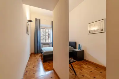 a room with a bedroom with a bed and a window at GuestHost - Trastevere Delightful Apartment in Rome