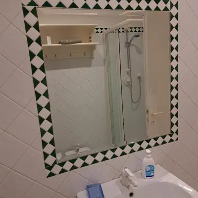 a bathroom with a mirror and a sink at HOUSE UP TO THE HILL - stanza con soggiorno a Monteverde vecchio in Rome
