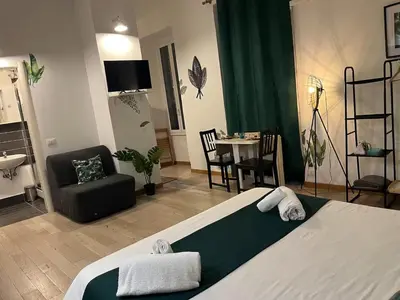 a bedroom with a bed and a chair and a table at L’oasi di Trastevere in Rome