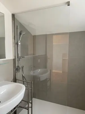 a bathroom with a sink and a glass shower at Piccolomini Design Apartment in Rome