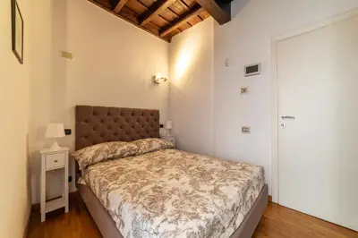 a bedroom with a large bed and a door at GuestHost - Piazza di Spagna Classy Apartment in Rome