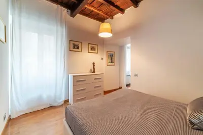 a bedroom with a bed and a dresser at GuestHost - Piazza di Spagna Classy Apartment in Rome