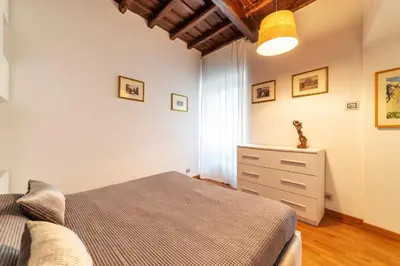 a bedroom with a bed and a dresser at GuestHost - Piazza di Spagna Classy Apartment in Rome