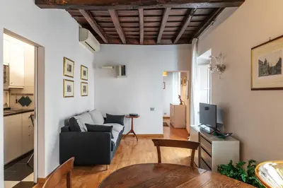 a living room with a couch and a table at GuestHost - Piazza di Spagna Classy Apartment in Rome