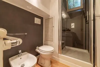 a bathroom with a toilet and a shower and a sink at GuestHost - Piazza di Spagna Classy Apartment in Rome