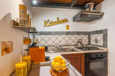 a kitchen with a bowl of fruit on a counter at L'antico borgo di Trastevere II in Rome