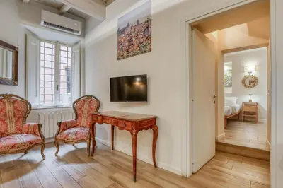 a home office with a wooden table and two chairs at Easybnb - Domus Orbitelli in Rome