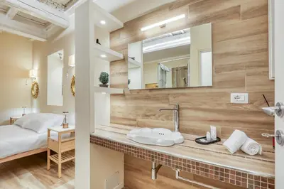a bathroom with a sink and a mirror at Easybnb - Domus Orbitelli in Rome