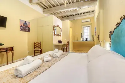 a bedroom with a large bed with towels on it at Easybnb - Domus Orbitelli in Rome