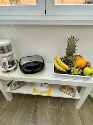 a plate of fruit on a shelf in a kitchen at Paradise Suite Roma centro in Rome