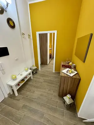 a kitchen with white cabinets and a table with food on it at Paradise Suite Roma centro in Rome