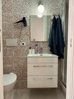 a bathroom with a sink and a toilet and a mirror at Guesthouse Dahlia Rossa in Rome