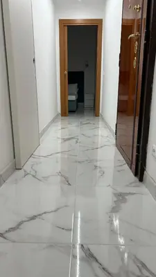 a hallway with a marble floor in a building at Guesthouse Dahlia Rossa in Rome