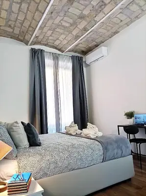 a bedroom with a bed in a room at Mamomi HOUSE in Rome