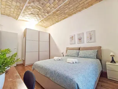 a bedroom with a bed with two towels on it at Mamomi HOUSE in Rome