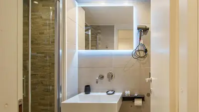 a bathroom with a white sink and a mirror at Ripetta Boutique Suites in Rome