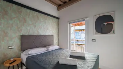 a bedroom with a bed and a table and a window at Ripetta Boutique Suites in Rome