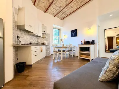 a kitchen and living room with a table and chairs at Enjoy Vatican Holiday in Rome in Rome