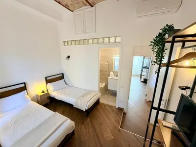 a bedroom with two beds and a room with a mirror at Enjoy Vatican Holiday in Rome in Rome