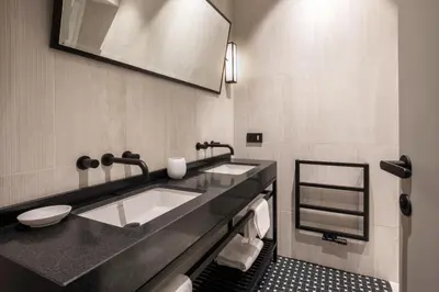 a bathroom with two sinks and a toilet in it at Ripetta Luxury Apartments in Rome