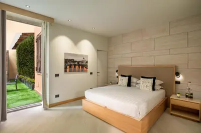 a bedroom with a bed and a large window at Ripetta Luxury Apartments in Rome