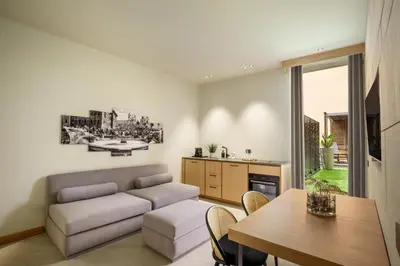 a living room with a couch and a table at Ripetta Luxury Apartments in Rome