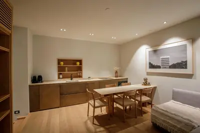 a kitchen with a table and a sink in a room at Ripetta Luxury Apartments in Rome