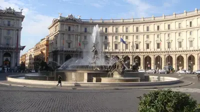 a fountain in front of a large building at Princess house Roma in Rome
