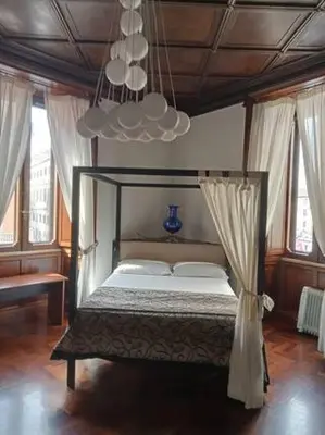 a bedroom with a bed with a canopy and windows at Princess house Roma in Rome