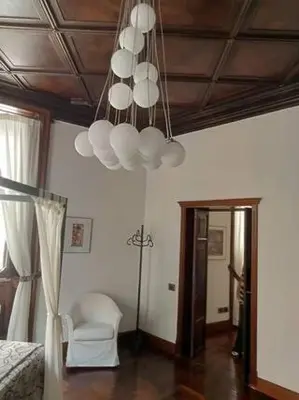 a bedroom with a bed and a chandelier at Princess house Roma in Rome